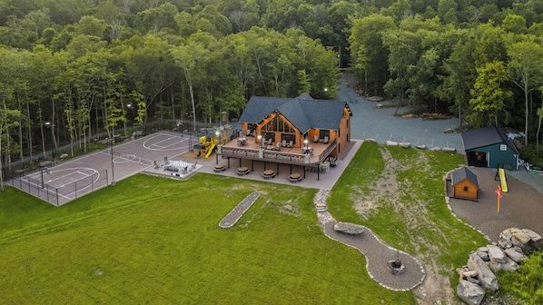 Aerial view of A&A Cabin lodge with basketball court, playground and fire pit