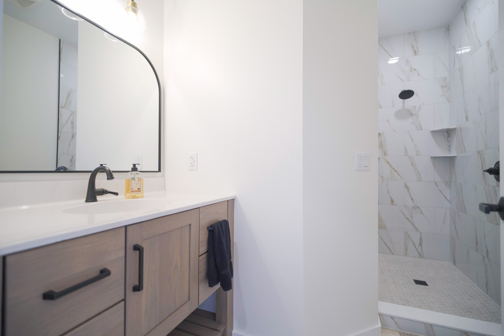The Tuscarora — bathroom with marble-tile shower