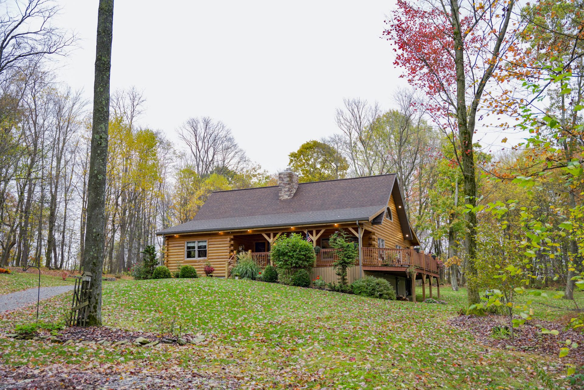 Side view of the Rancik log home on a landscaped hillside