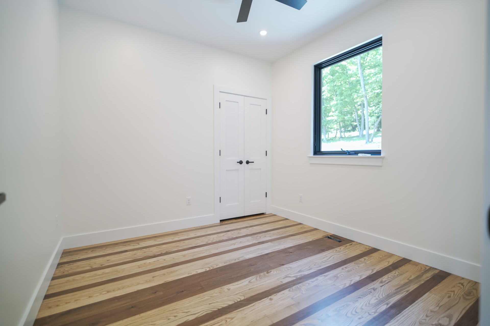 The Tuscarora — bedroom with mixed-species hardwood floors