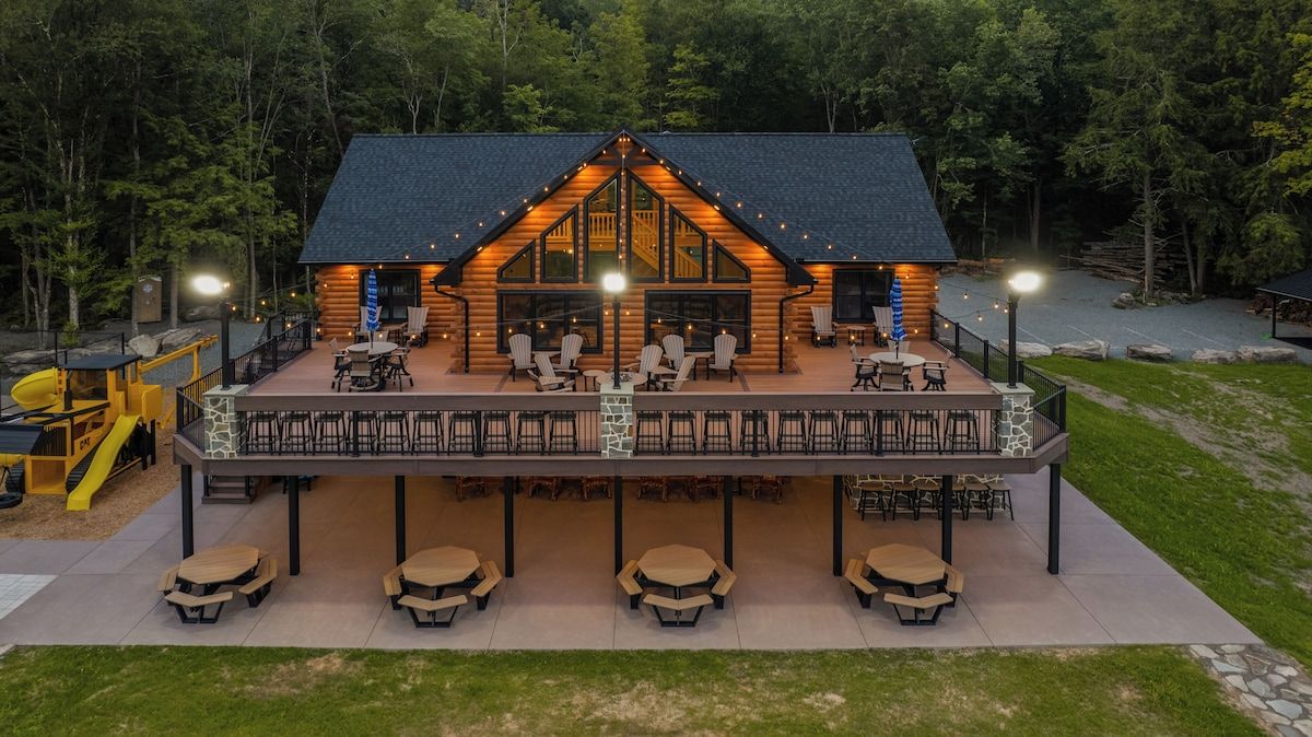 Aerial view of A&A Cabin lodge deck and outdoor dining area at twilight