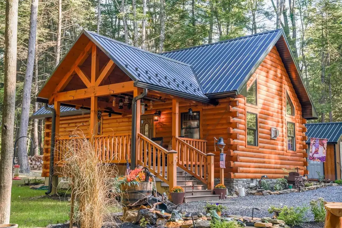 Rustic log cabin package with covered porch by KSM Log Homes and Timber Packages