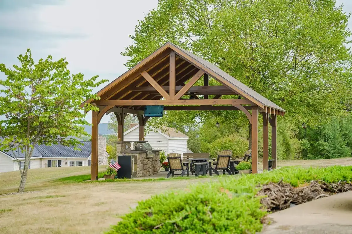 Custom timber-frame pavilion with king post trusses by KSM Log Homes and Timber Packages